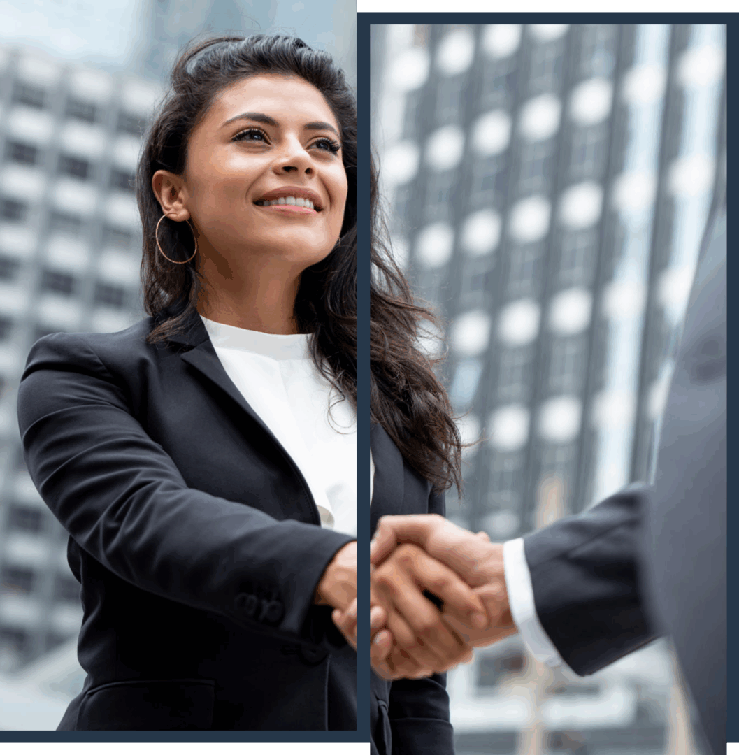 Businesswoman shaking hands in urban setting.