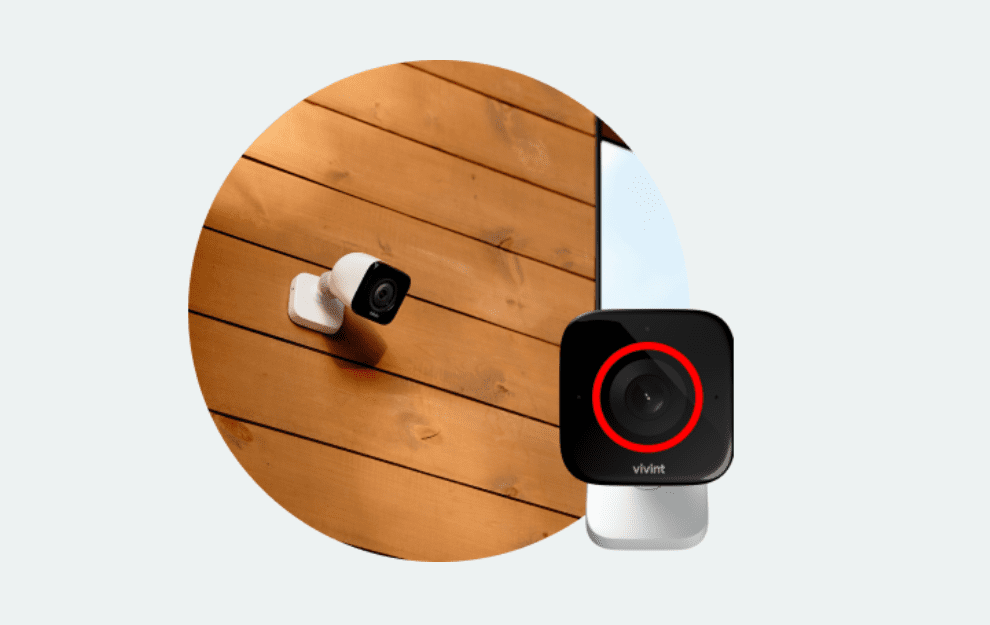 A modern security camera mounted on a wooden ceiling.